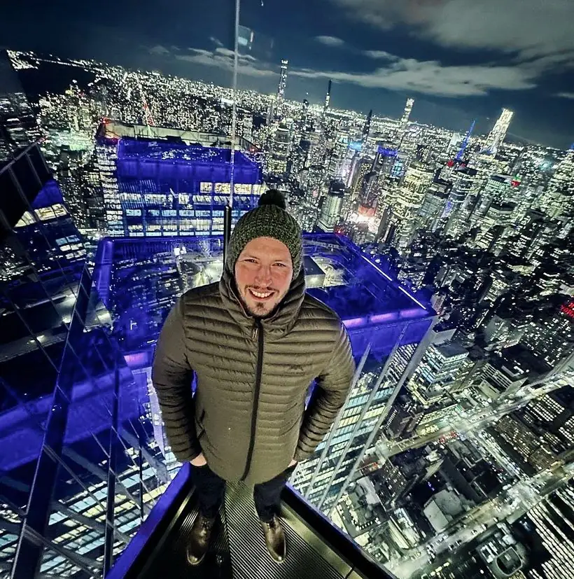 Ian Sharpe above the Manhattan skyline at night